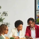 Three colleagues working together at a wooden table